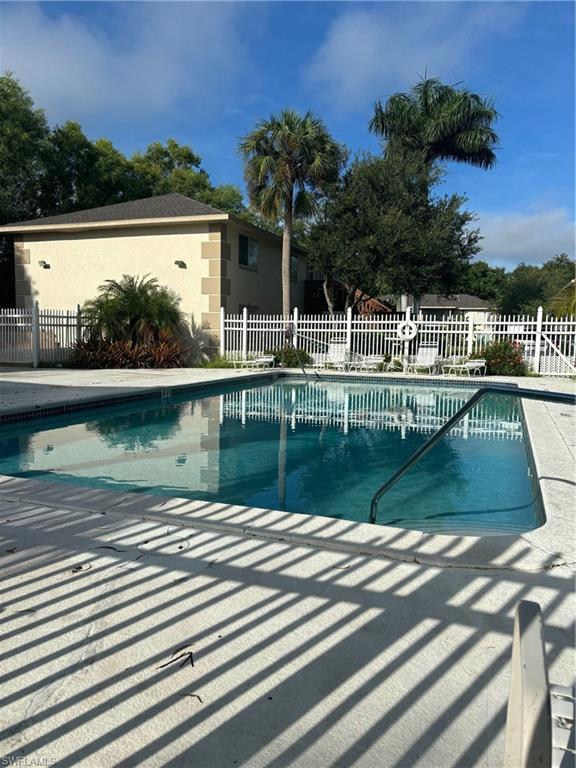 5386 16th Place Southwest, Unit F4 Naples, FL 34116 - Photo 1 of 11 a view of swimming pool with a lake view