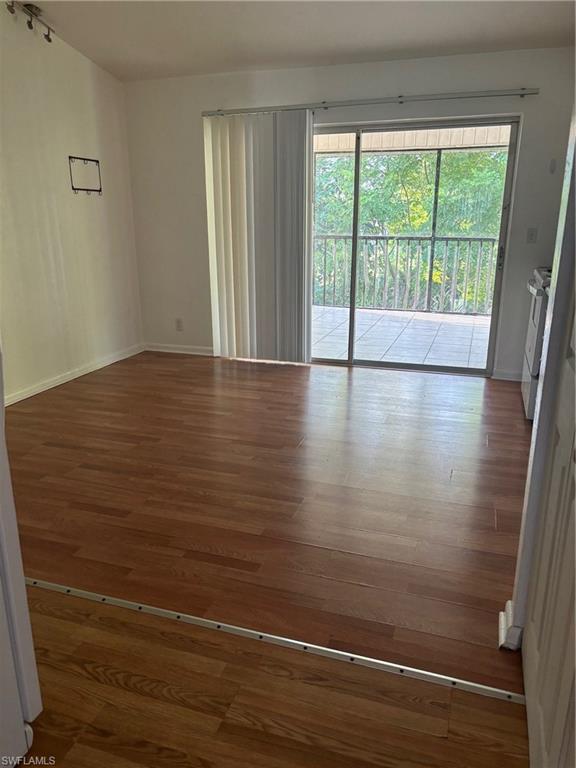5386 16th Place Southwest, Unit F4 Naples, FL 34116 - Photo 3 of 11 a view of empty room with wooden floor and fan