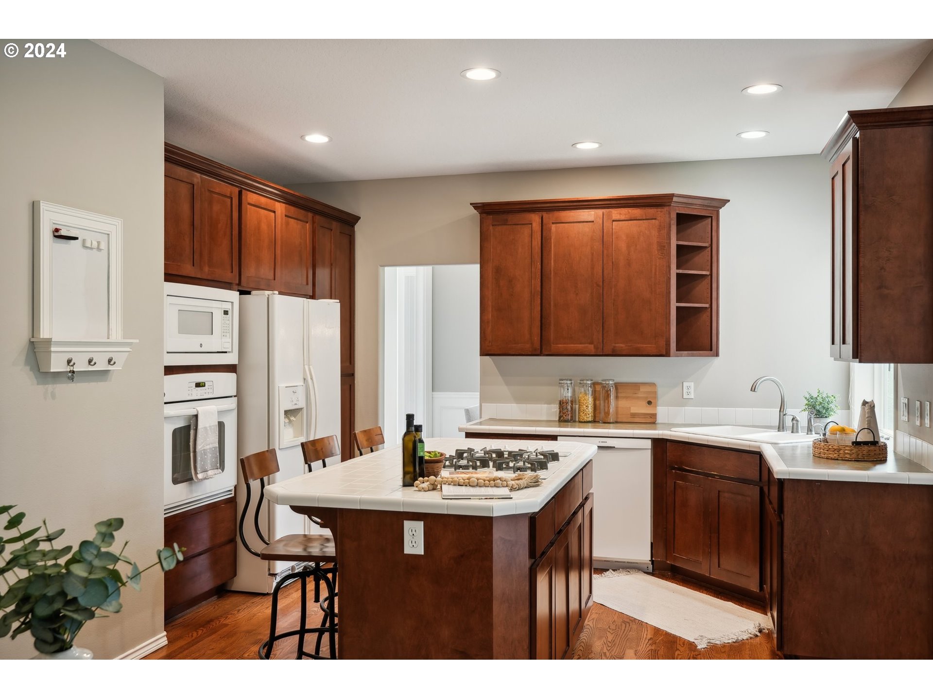 9267 Southwest 83rd Place Portland, OR 97223 - Photo 11 of 44 a kitchen with stainless steel appliances kitchen island granite countertop a sink and cabinets