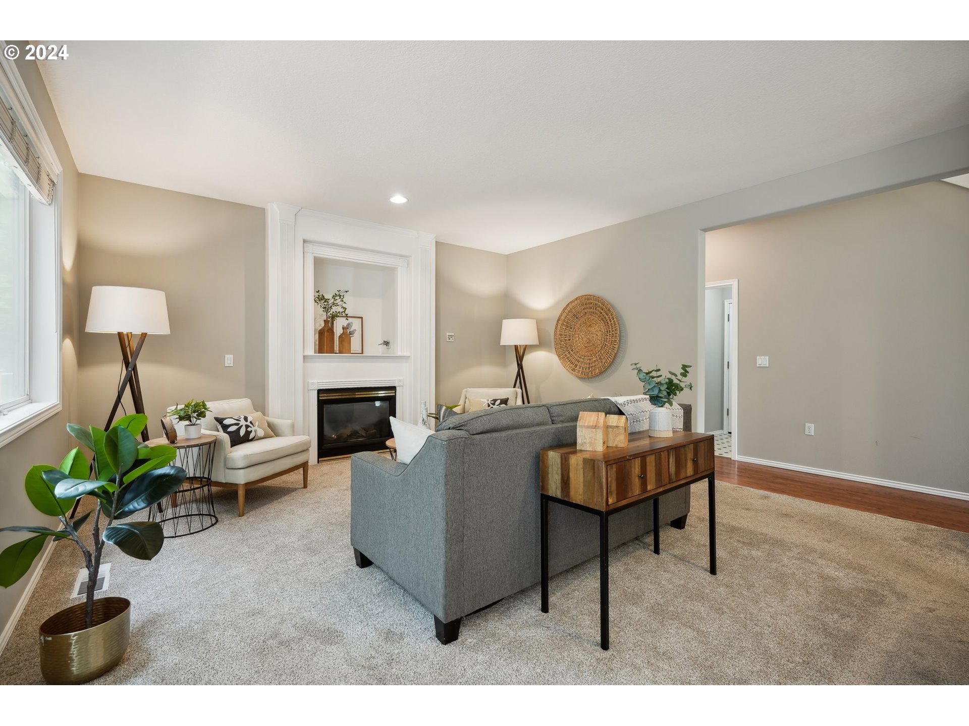 9267 Southwest 83rd Place Portland, OR 97223 - Photo 17 of 44 a living room with furniture a fireplace and a potted plant