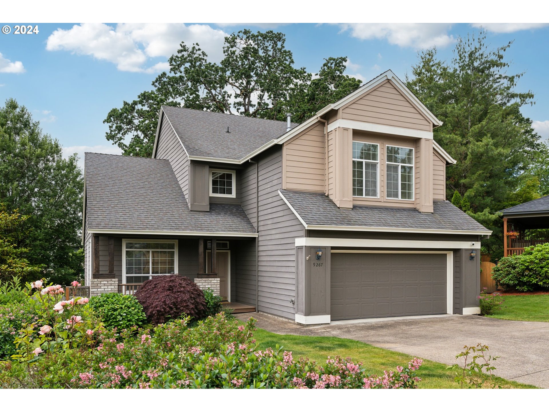9267 Southwest 83rd Place Portland, OR 97223 - Photo 2 of 44 a front view of a house with yard and trees