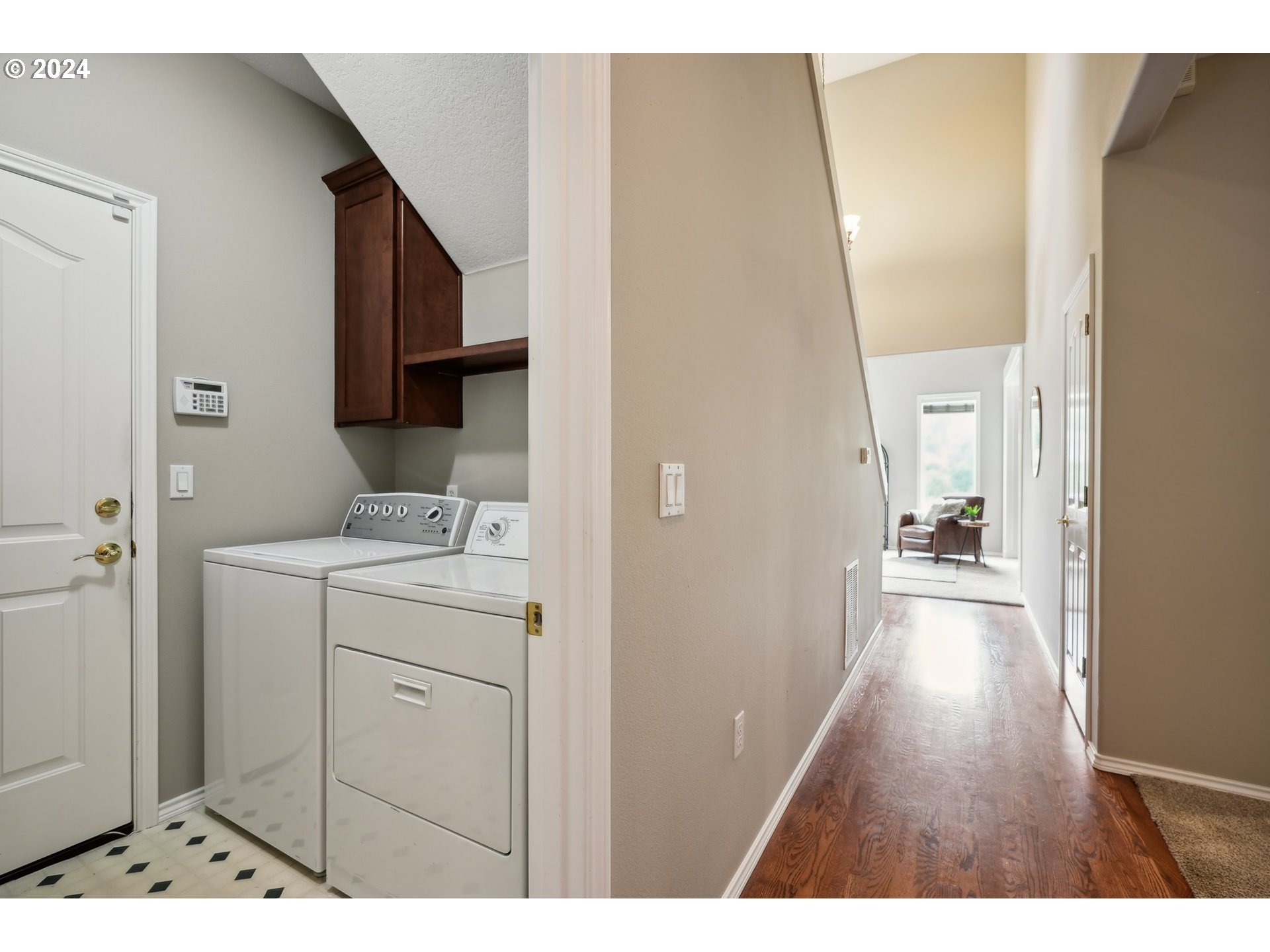 9267 Southwest 83rd Place Portland, OR 97223 - Photo 21 of 44 a view of a hallway with wooden floor and cabinets