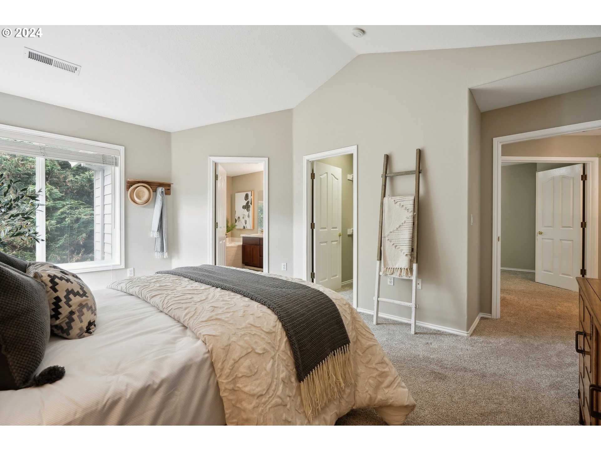 9267 Southwest 83rd Place Portland, OR 97223 - Photo 26 of 44 a bedroom with a bed and large windows