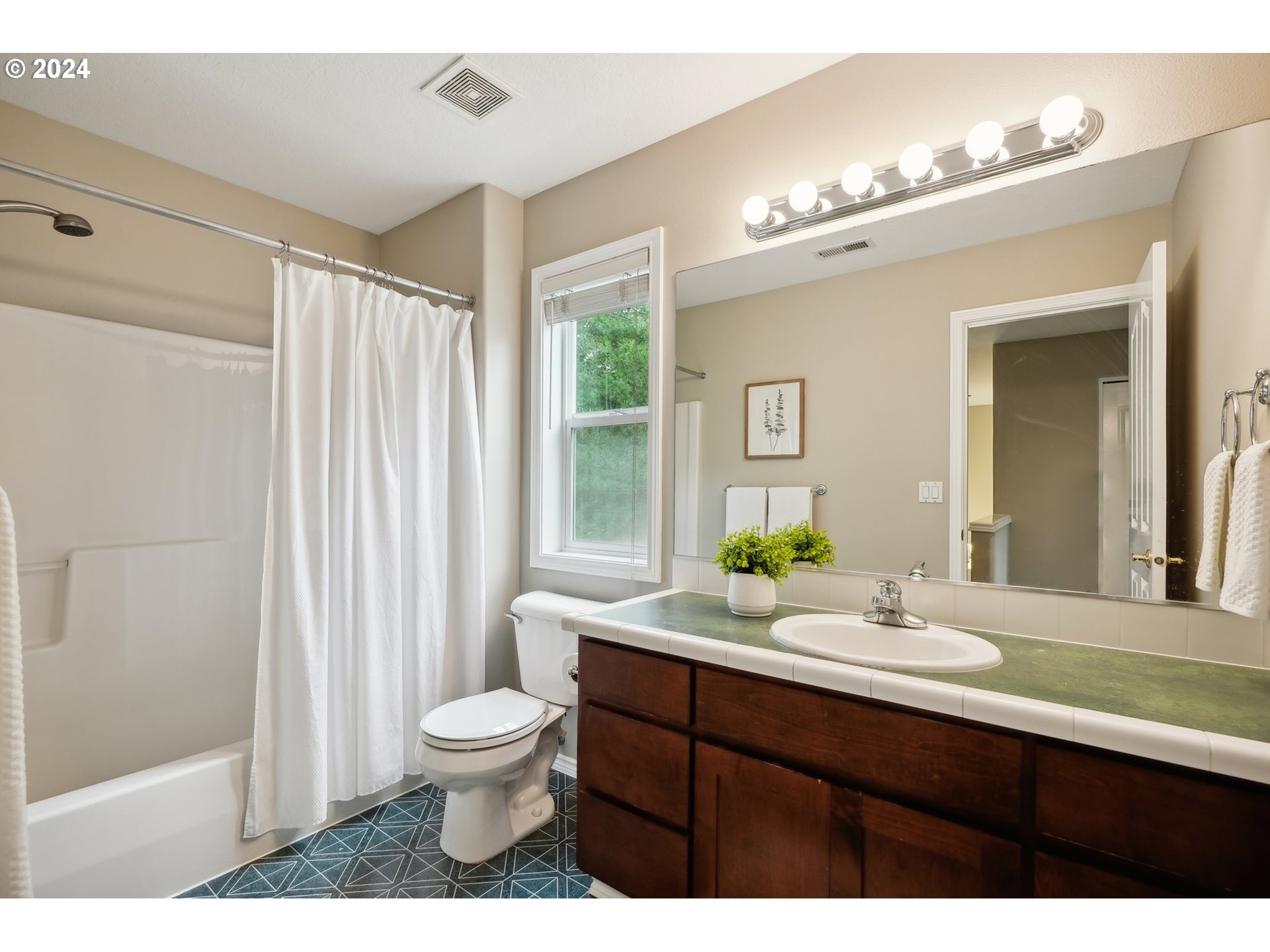 9267 Southwest 83rd Place Portland, OR 97223 - Photo 31 of 44 a bathroom with a double vanity sink toilet and a mirror