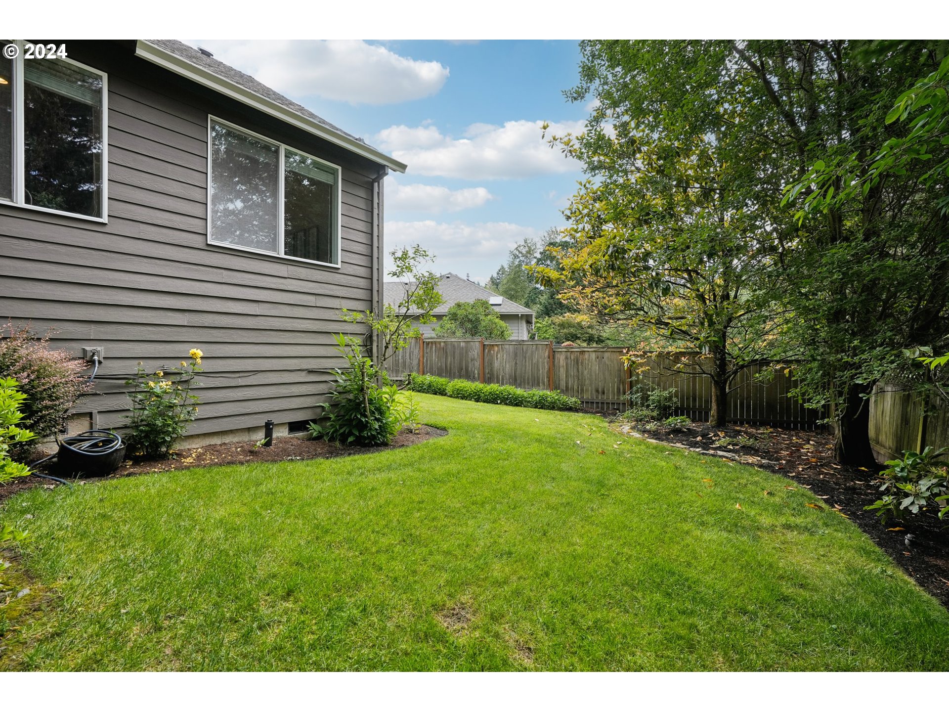 9267 Southwest 83rd Place Portland, OR 97223 - Photo 41 of 44 a view of a backyard with plants and large tree