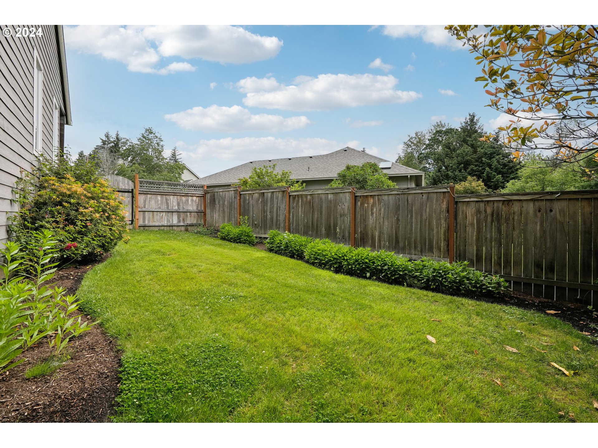 9267 Southwest 83rd Place Portland, OR 97223 - Photo 42 of 44 a view of a backyard with a lake