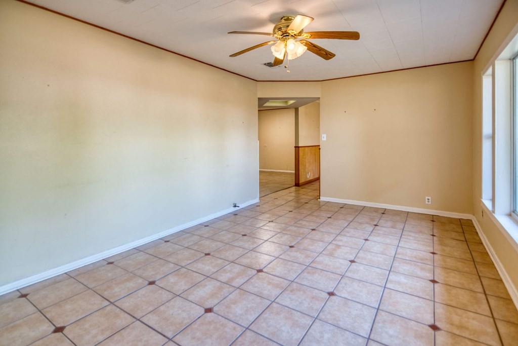 511 East Rainey Street Mason, TX 76856 - Photo 2 of 63 a view of an empty room and window with a chandelier fan