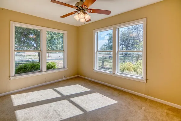 a view of a room with a window and a ceiling fan