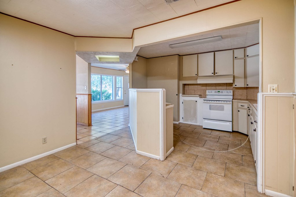 511 East Rainey Street Mason, TX 76856 - Photo 23 of 63 a kitchen with white cabinets and white appliances