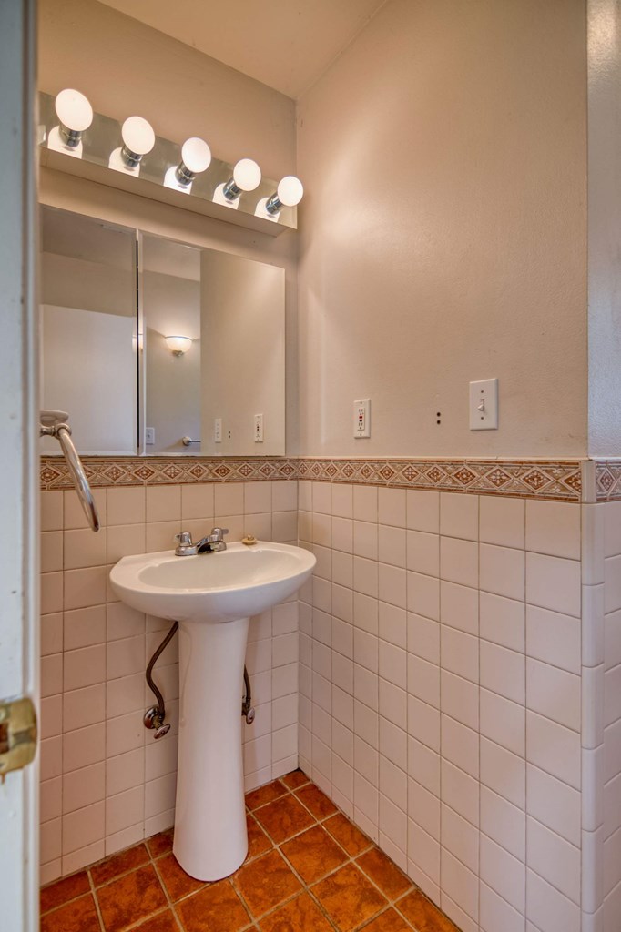 511 East Rainey Street Mason, TX 76856 - Photo 30 of 63 a bathroom with a sink a toilet and mirror