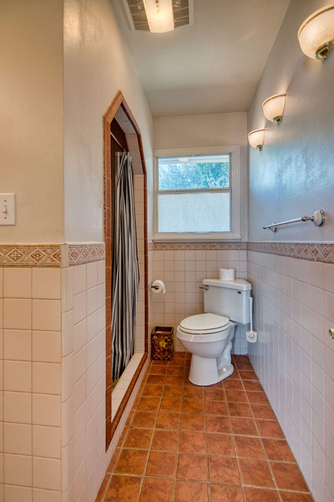 511 East Rainey Street Mason, TX 76856 - Photo 36 of 63 a bathroom with a toilet a sink and mirror