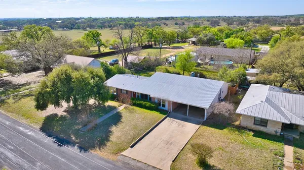 an aerial view of a house with a yard