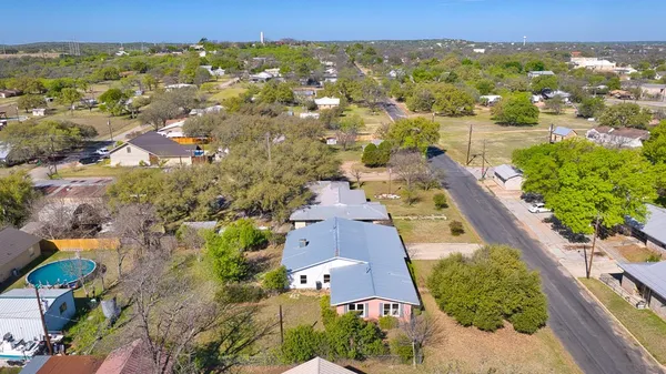 an aerial view of a house with yard swimming pool and outdoor seating