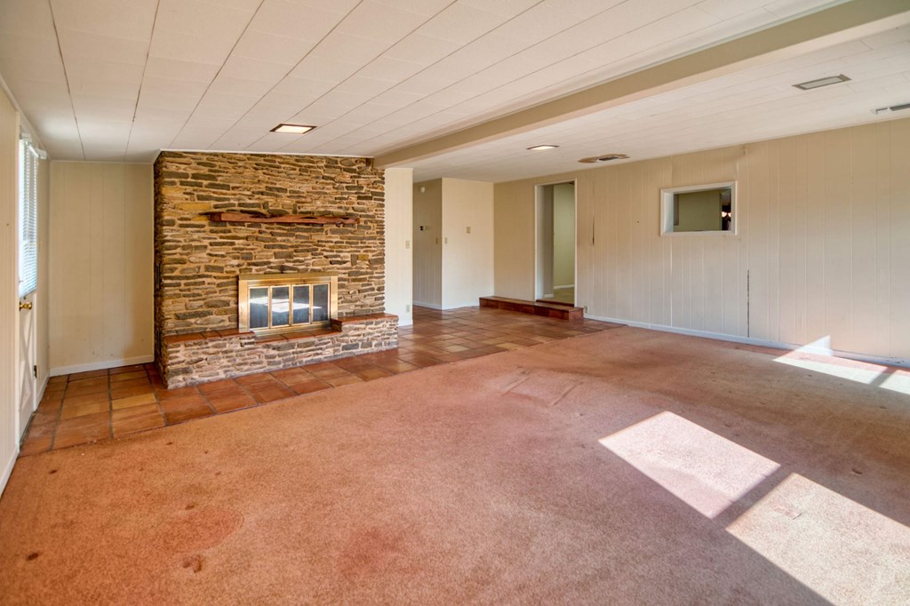 511 East Rainey Street Mason, TX 76856 - Photo 7 of 63 a view of an empty room with a fireplace and a window