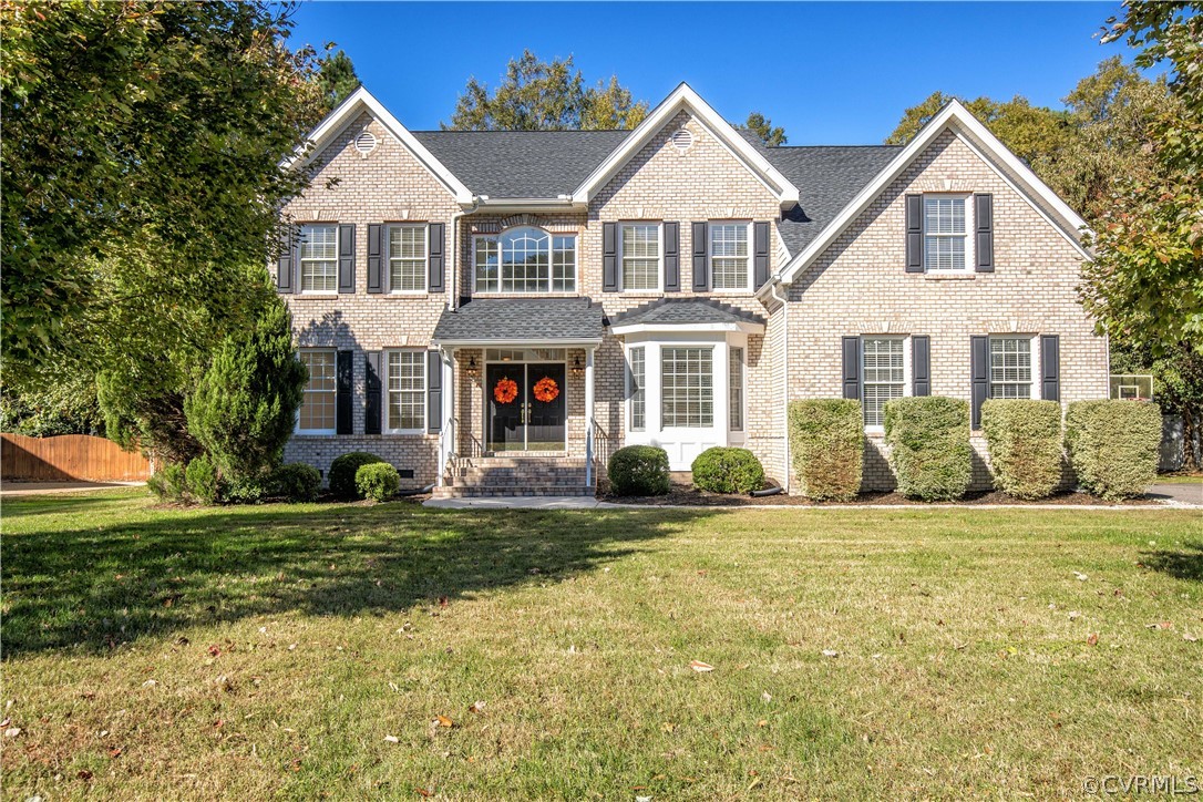 a front view of a house with a yard