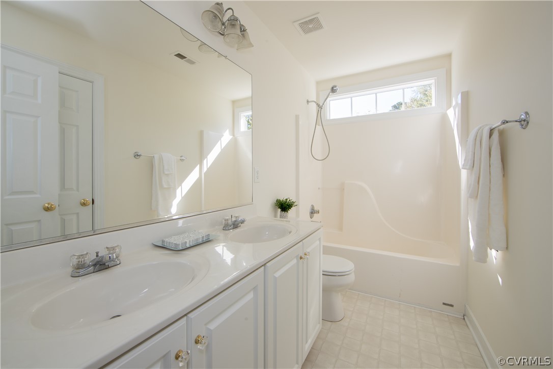 846 Club Ridge Terrace Chester, VA 23836 - Photo 20 of 35 a bathroom with a double vanity sink toilet mirror and shower