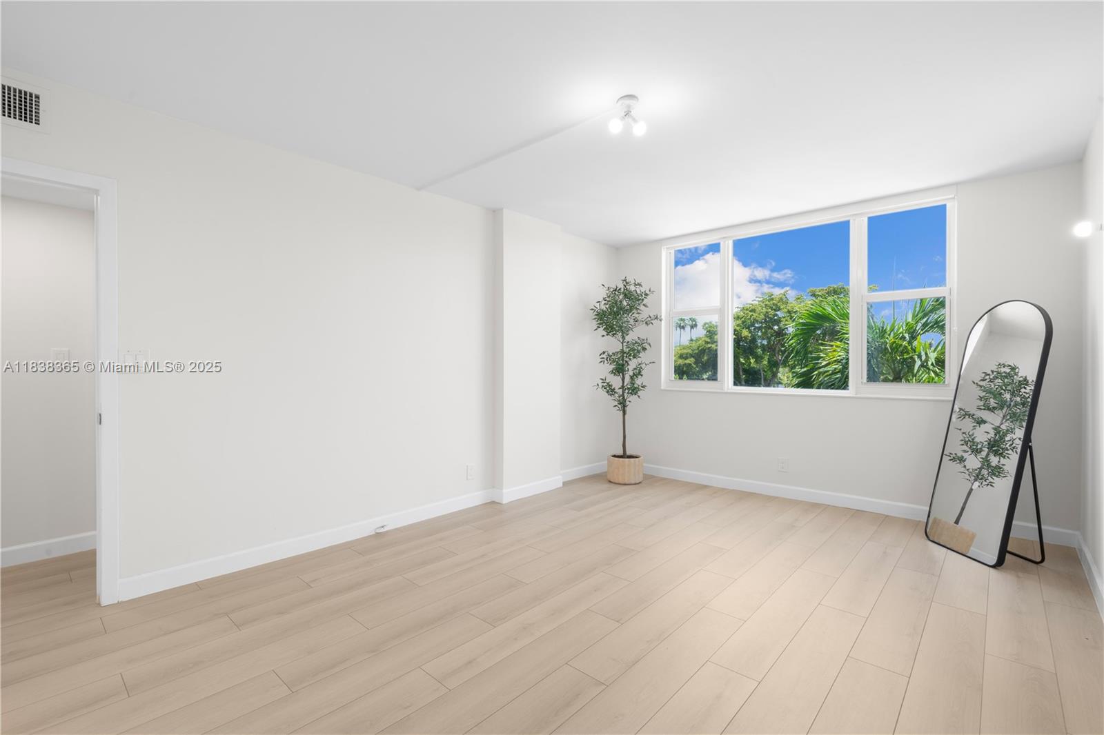 4400 Hillcrest Drive, Unit 314B Hollywood, FL 33021 - Photo 19 of 25 a view of an empty room with a window and wooden floor