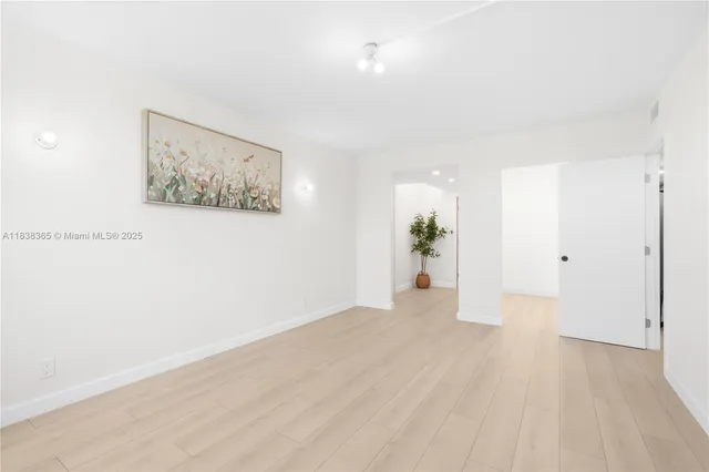 a view of a big room with wooden floor and potted plant