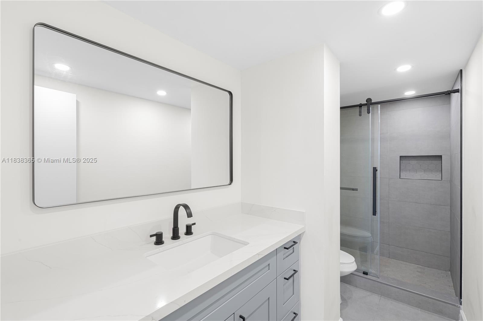 4400 Hillcrest Drive, Unit 314B Hollywood, FL 33021 - Photo 22 of 25 a bathroom with a sink and a mirror