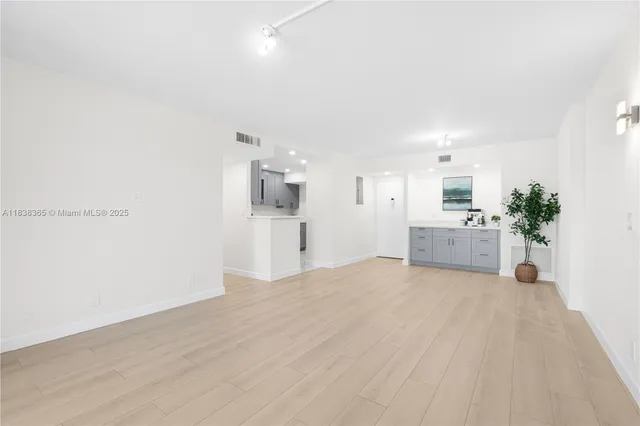a view of a kitchen with a sink and a refrigerator