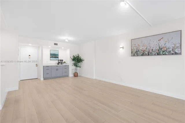 a view of a kitchen with microwave and cabinets
