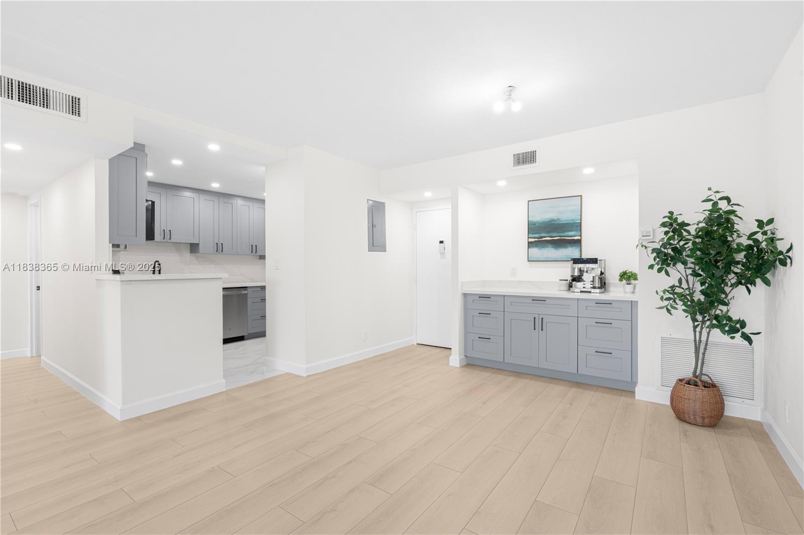 4400 Hillcrest Drive, Unit 314B Hollywood, FL 33021 - Photo 7 of 25 a large white kitchen with a sink and cabinets