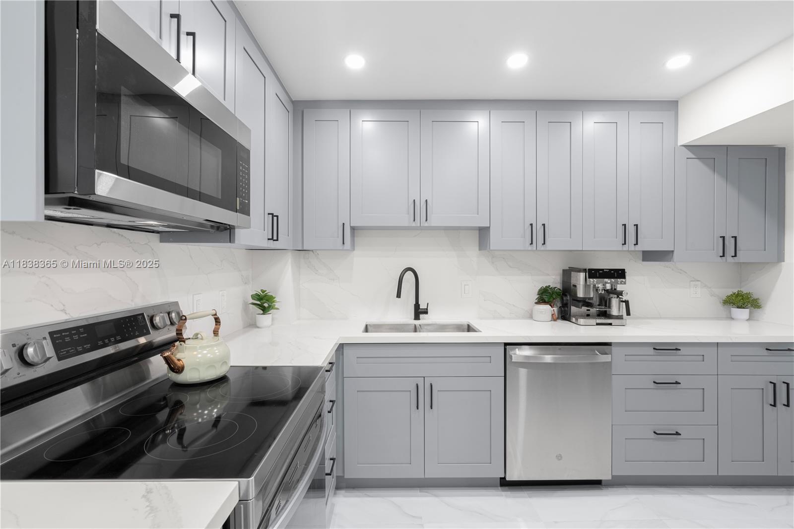 4400 Hillcrest Drive, Unit 314B Hollywood, FL 33021 - Photo 9 of 25 a kitchen with stainless steel appliances granite countertop a sink stove and microwave