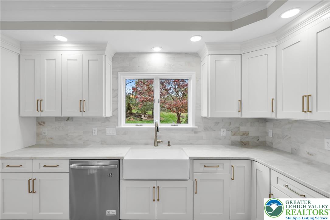 3685 Manor Road Bethlehem, PA 18020 - Photo 11 of 47 a kitchen with stainless steel appliances granite countertop a sink a window and white cabinets
