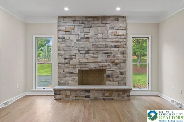 a living room with a fireplace and a floor to ceiling window