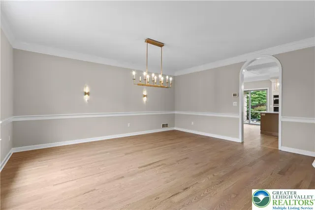 an empty room with windows and fireplace