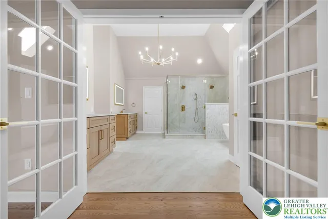 a spacious bathroom with a glass shower door and a sink