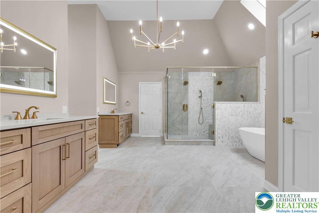 3685 Manor Road Bethlehem, PA 18020 - Photo 26 of 47 a bathroom with a double vanity sink a toilet a mirror and shower