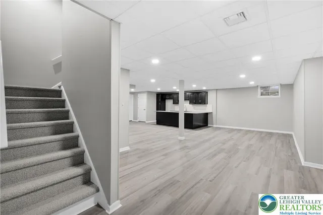 a view of an empty room with a kitchen