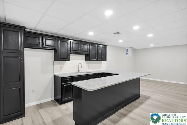 a kitchen with stainless steel appliances granite countertop a sink a stove and a refrigerator