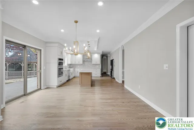 a view of a kitchen with refrigerator and window