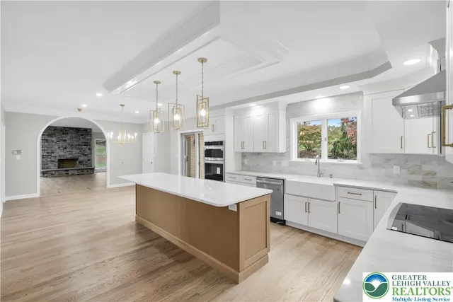 a large white kitchen with a large window