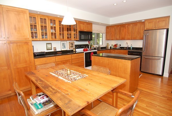 9 Camden Place Cambridge, MA 02138 - Photo 3 of 16 a kitchen with stainless steel appliances granite countertop a refrigerator a stove and a sink with granite countertops