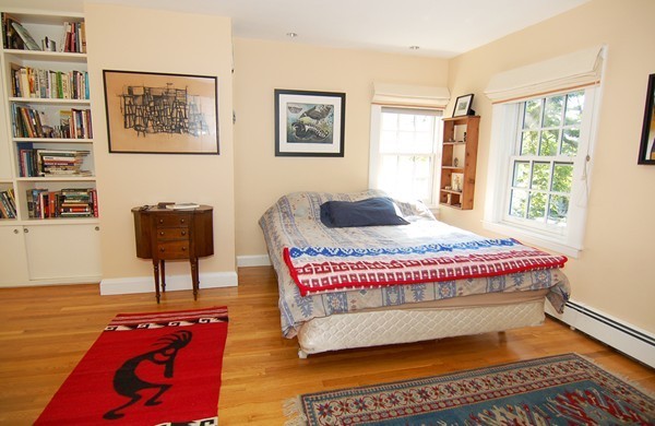 9 Camden Place Cambridge, MA 02138 - Photo 7 of 16 a bedroom with a bed and wooden floor