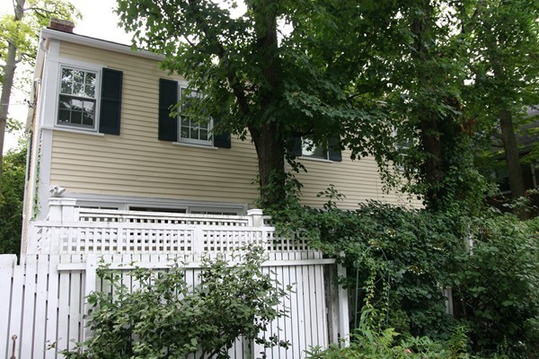 9 Camden Place Cambridge, MA 02138 - Photo 10 of 16 a side view of a house with a tree