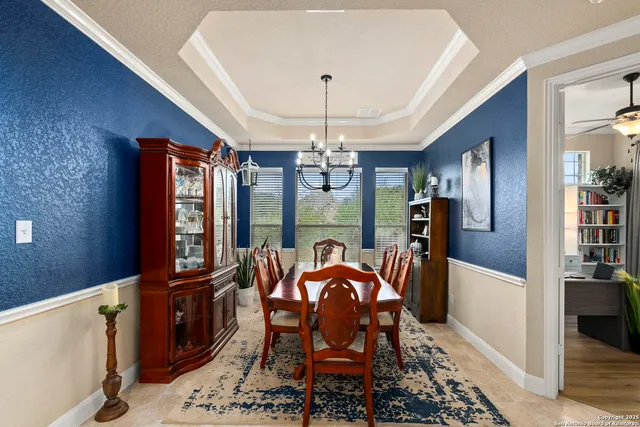 a living room with furniture a large window and a fireplace