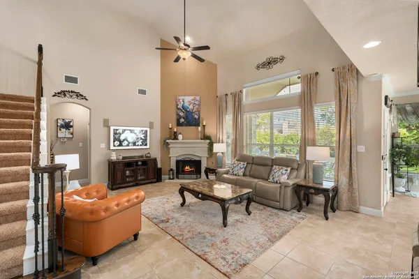 a spacious bathroom with a granite countertop sink a mirror a bathtub and a shower