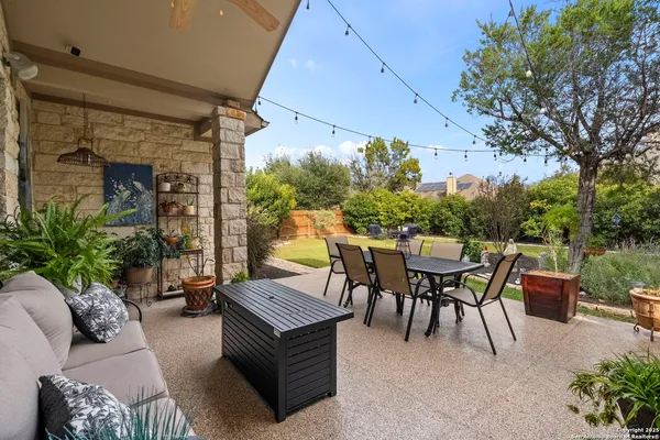 a view of a swimming pool and lounge chairs in the patio