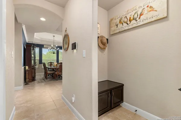 a living room with furniture a flat screen tv and a window