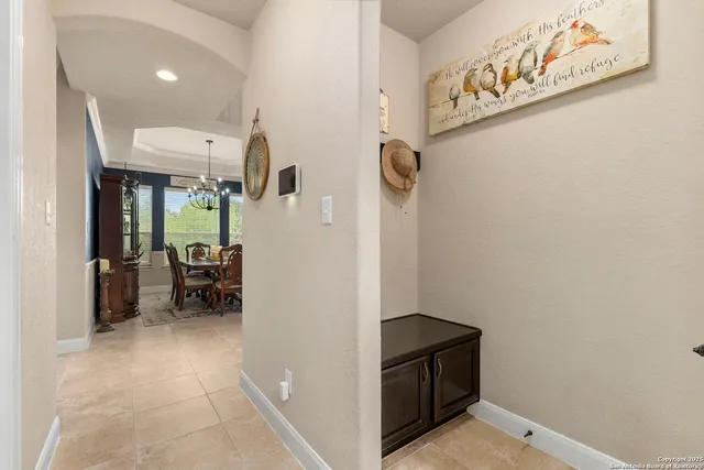 a living room with furniture a flat screen tv and a window