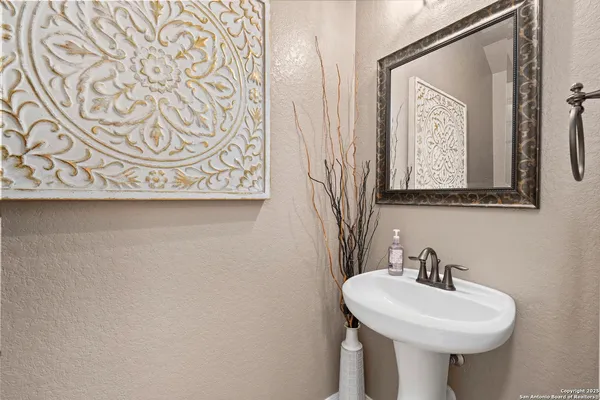 a living room with furniture a dining table and paintings on the wall