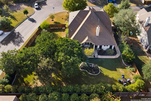 a aerial view of a house next to a yard