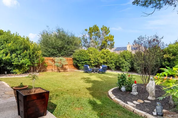 a aerial view of a house next to a yard