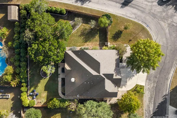 an aerial view of a residential houses with outdoor space and street view
