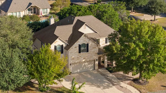 an aerial view of a residential houses with outdoor space and street view