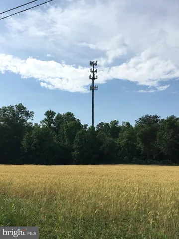 a picture of a white building with wooden fence